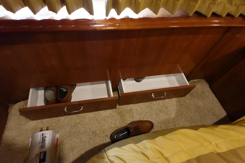 Slide: The Image of Drawers with shoes in a 2004 Carver 396 Aft Cabin MY interior. - 29