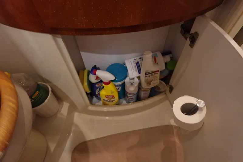 Slide: The Image of Storage cabinet with cleaning supplies in a 2004 Carver 396 Aft Cabin MY bathroom. - 35