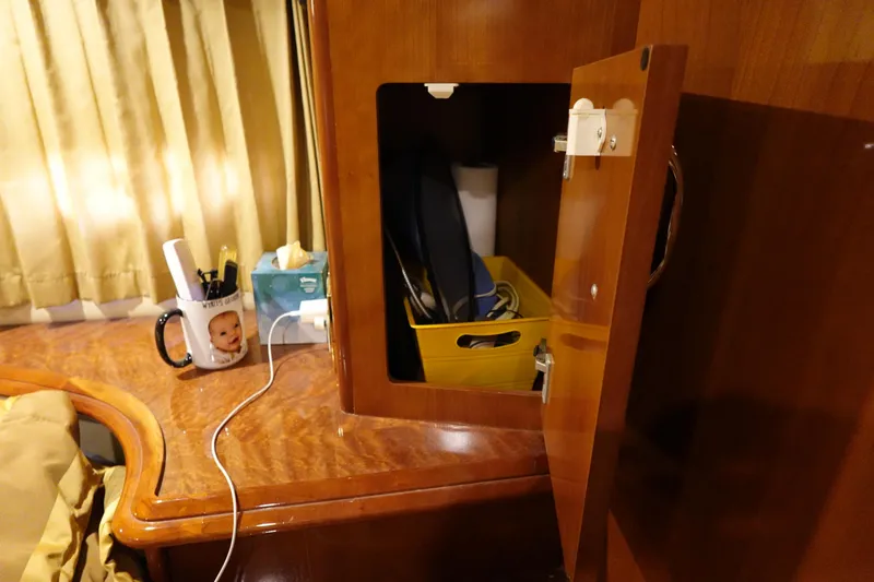 Slide: The Image of 2004 Carver 396 Aft Cabin MY interior with open cabinet and desk accessories. - 36