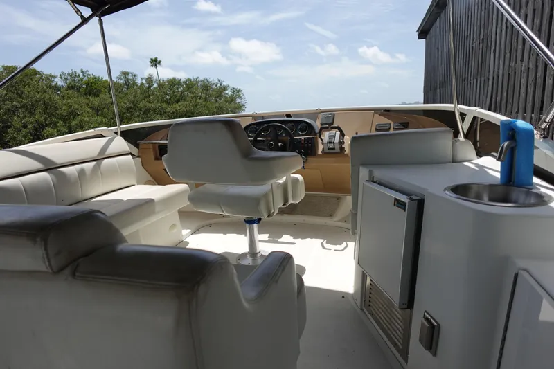 Slide: The Image of 2004 Carver 396 Aft Cabin MY yacht interior with helm, seating, and kitchenette. - 4