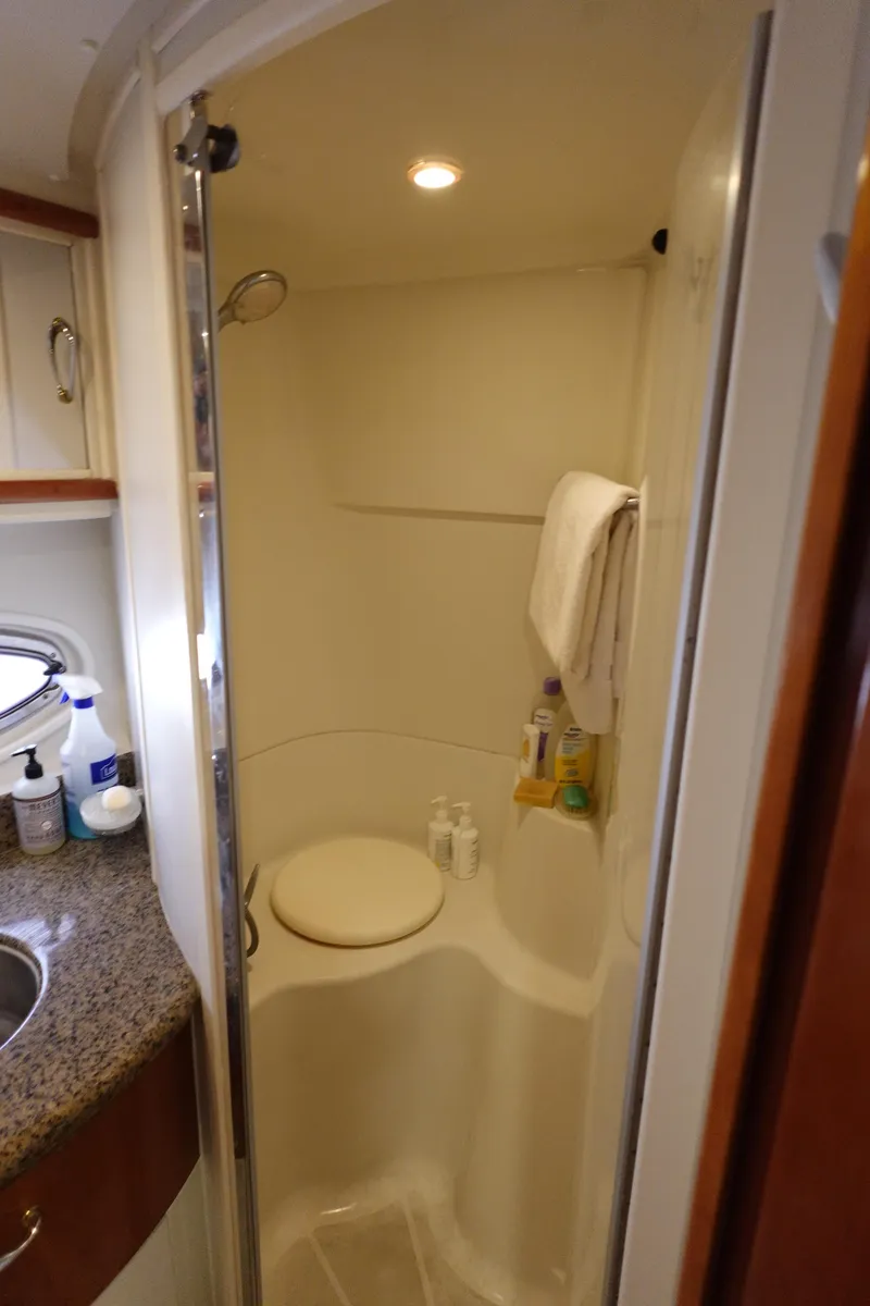 Slide: The Image of Compact bathroom in 2004 Carver 396 Aft Cabin MY yacht with shower and granite countertop. - 40