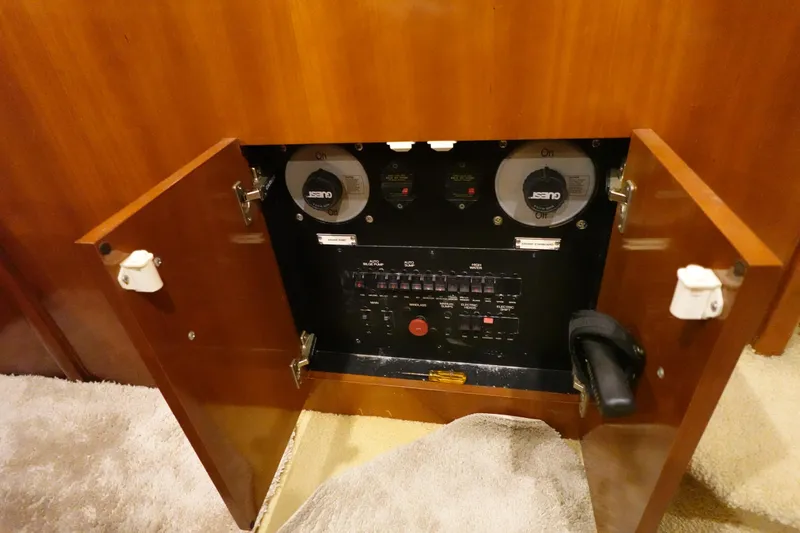 Slide: The Image of Electrical panel inside 2004 Carver 396 Aft Cabin MY, featuring switches and gauges. - 44