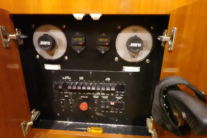 Slide: The Image of Electrical panel inside a 2004 Carver 396 Aft Cabin MY boat, featuring switches and controls. - 45