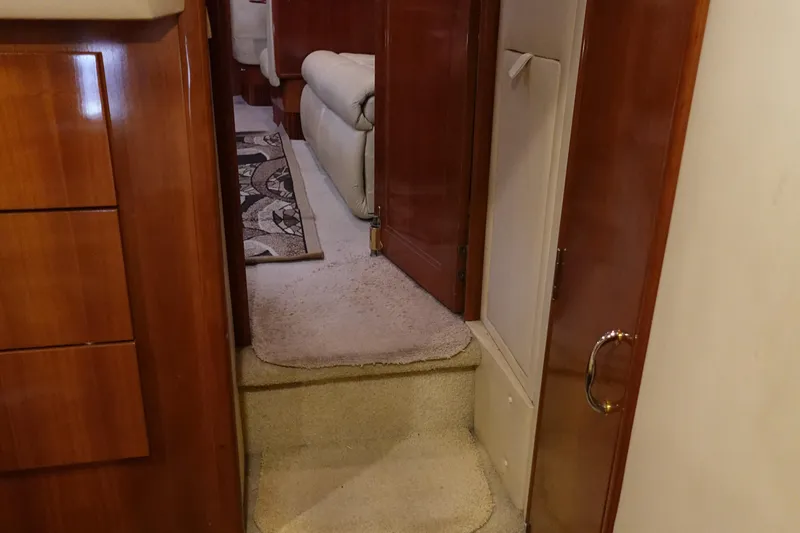 Slide: The Image of Interior of 2004 Carver 396 Aft Cabin MY with carpeted steps and wooden cabinetry. - 46
