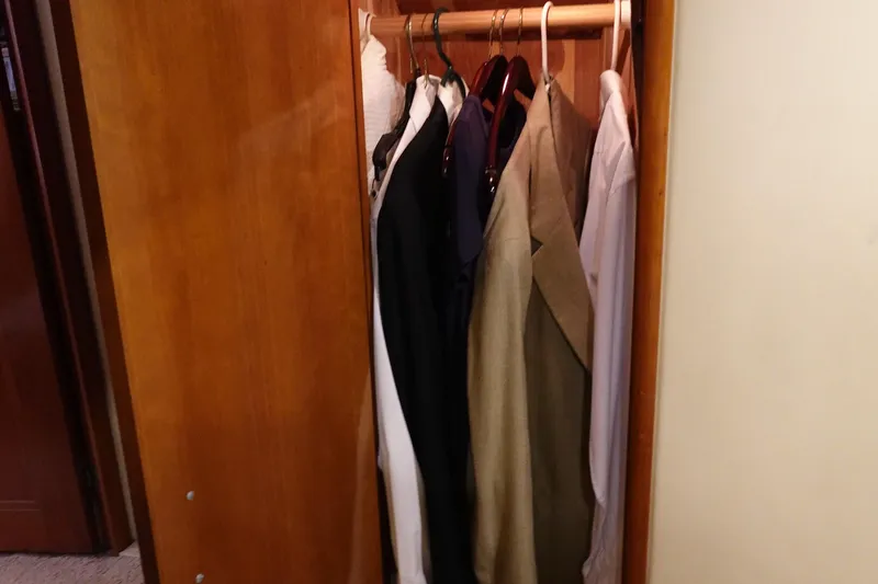 Slide: The Image of Wooden closet with hanging clothes inside a 2004 Carver 396 Aft Cabin MY. - 47