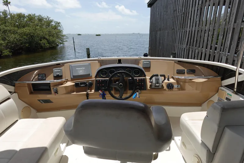 Slide: The Image of Helm of 2004 Carver 396 Aft Cabin MY with navigational equipment, overlooking serene waters. - 5