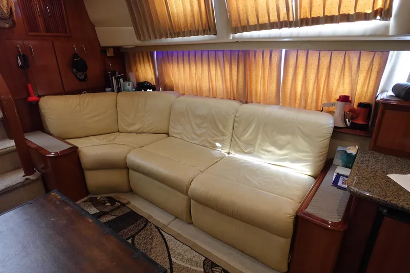 Slide: The Image of Luxurious interior of 2004 Carver 396 Aft Cabin MY with cream leather sofa and wooden accents. - 8