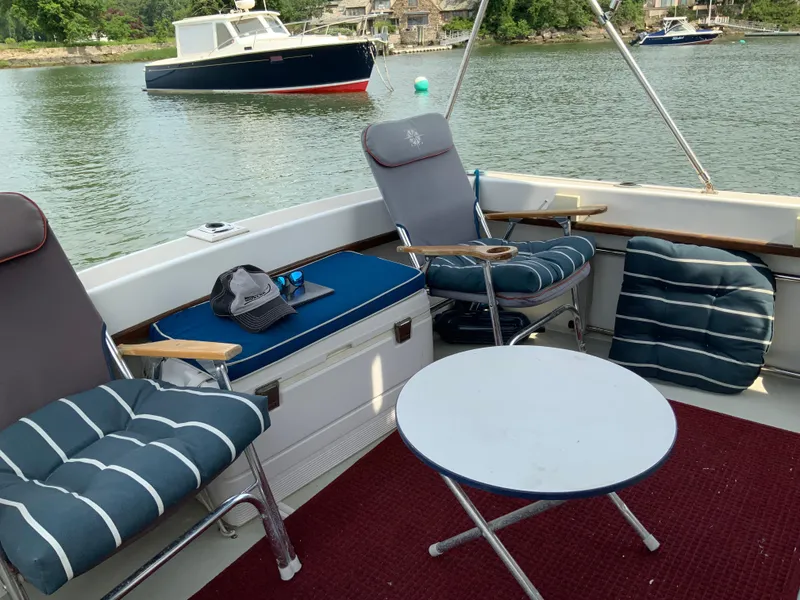 Slide: The Image of Cozy seating area on 1986 Cape Dory 26 Fly boat with scenic water view. - 3