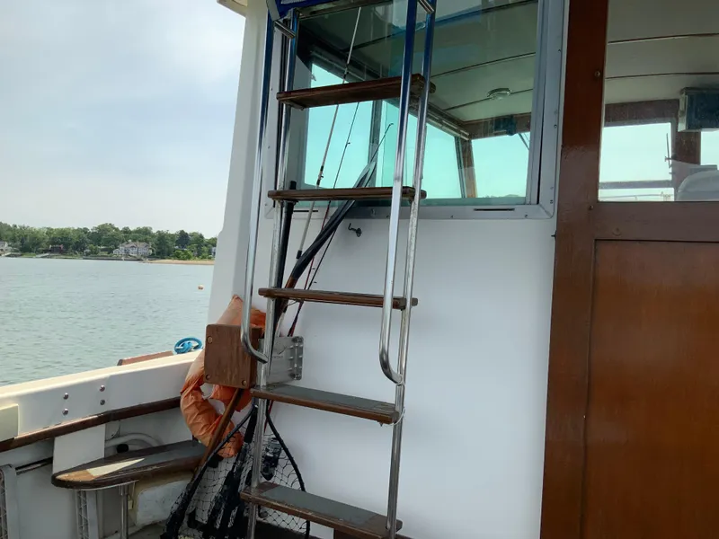 Slide: The Image of 1986 Cape Dory 26 Fly boat interior with ladder and fishing gear. - 4