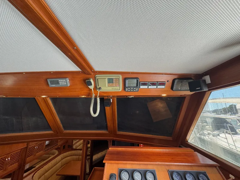Slide: The Image of Interior of 1990 Nova 48 boat cockpit with navigation instruments and wooden finish. - 12