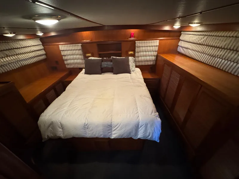 Slide: The Image of Cozy bedroom in 1990 Nova 48 yacht with wood paneling and soft lighting. - 17