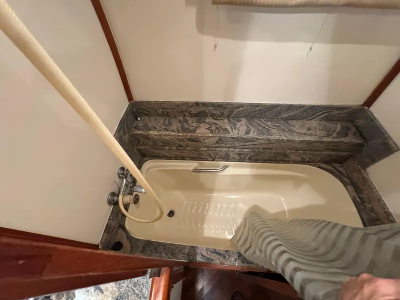 Slide: The Image of Compact bathroom with marble accents and a small bathtub in a 1990 Nova 48 model. - 19