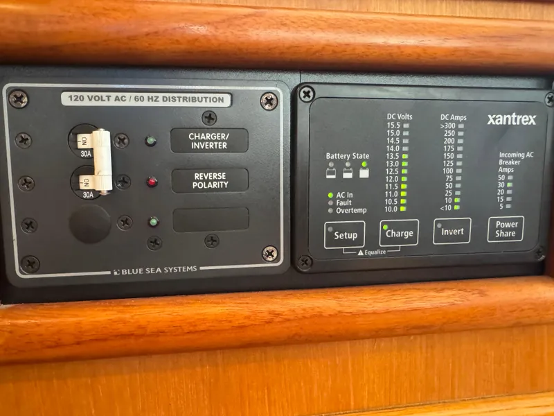 Slide: The Image of Electrical control panel with Blue Sea Systems and Xantrex components on a 1990 Nova 48. - 23