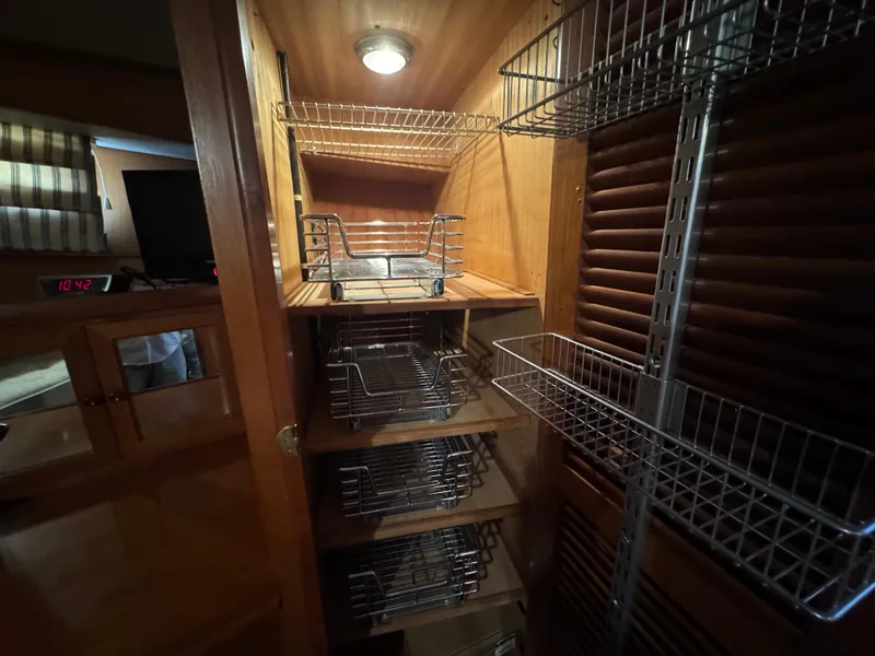 Slide: The Image of Wooden cabinet with metal wire shelves in a 1990 Nova 48 interior. - 29