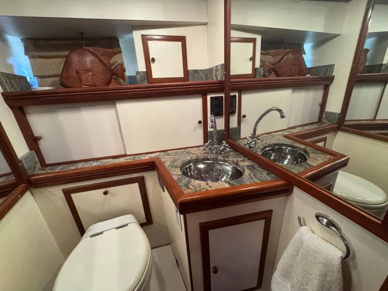Slide: The Image of Luxurious 1990 Nova 48 yacht bathroom with elegant wood trim and granite countertop. - 31