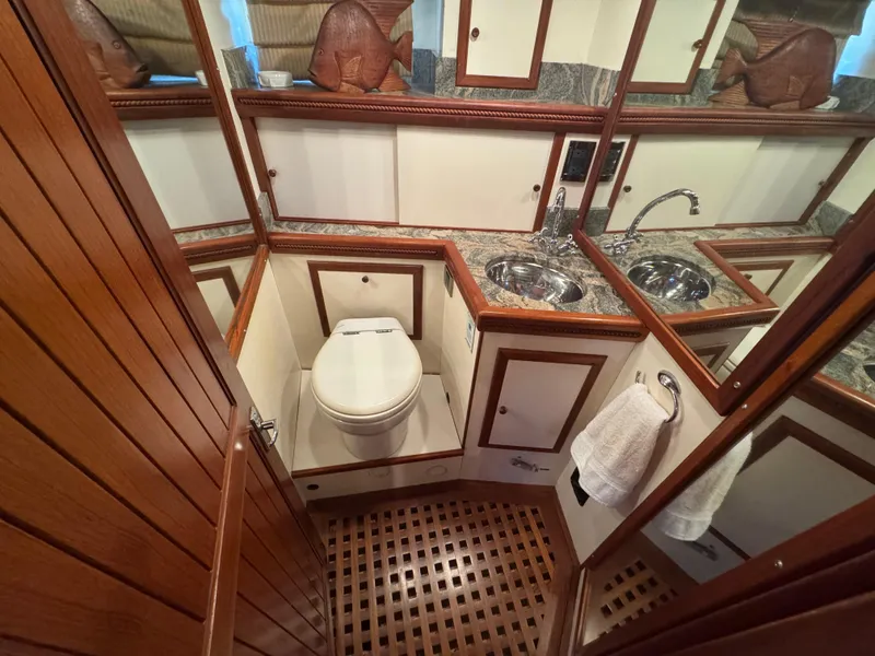 Slide: The Image of Luxurious 1990 Nova 48 yacht bathroom with wood accents and dual sinks. - 32