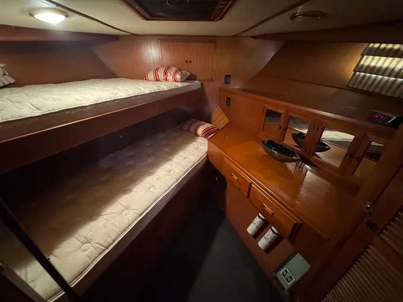 Slide: The Image of Cozy cabin interior with bunk beds and wooden furnishings on a 1990 Nova 48 boat. - 33