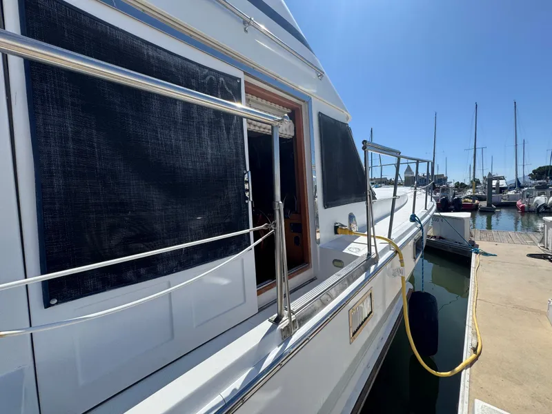 Slide: The Image of 1990 Nova 48 yacht docked at marina under clear blue sky. - 39