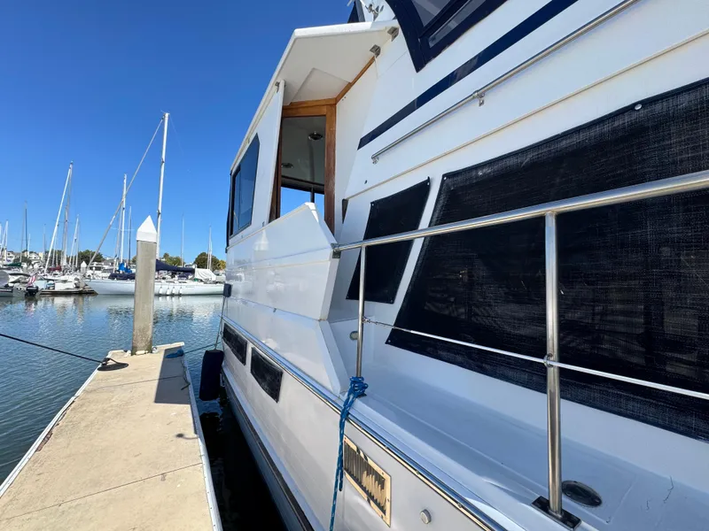 Slide: The Image of Nova 48 yacht from 1990 docked at a marina under clear blue skies. - 40