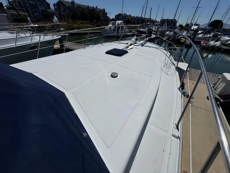 Slide: The Image of Deck of a 1990 Nova 48 yacht docked at a marina with sailboats. - 6