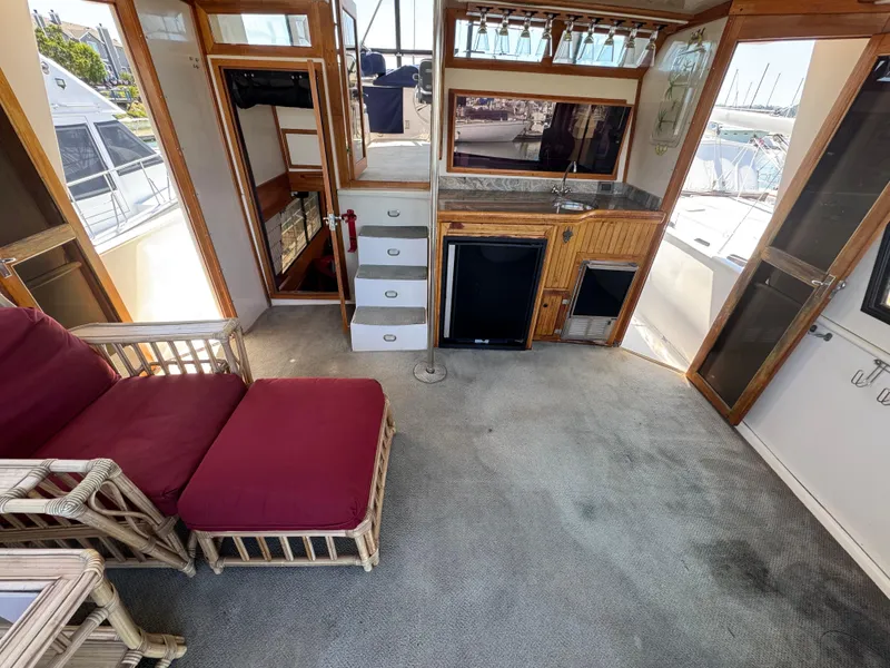 Slide: The Image of Interior of a 1990 Nova 48 yacht with kitchenette and seating area. - 7