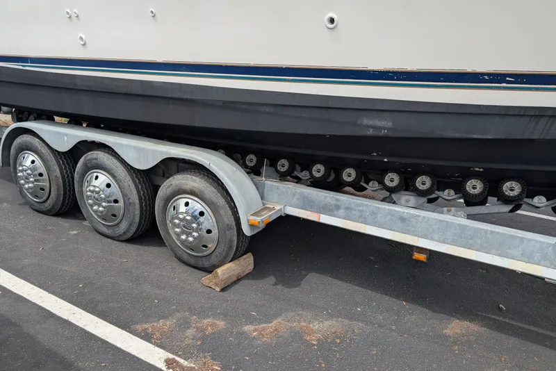 Slide: The Image of 1997 Bayliner 2859 Ciera Express on a multi-axle trailer in a parking lot. - 10