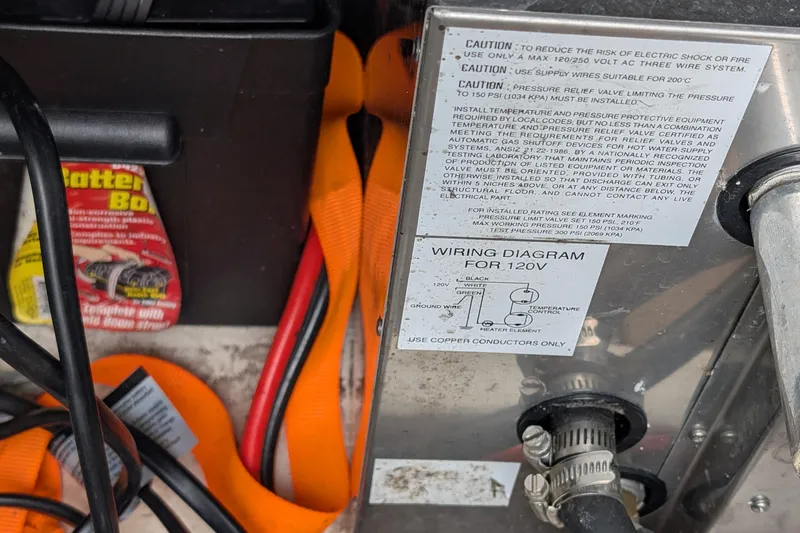 Slide: The Image of 1997 Bayliner 2859 Ciera Express wiring diagram and caution labels near battery box. - 14