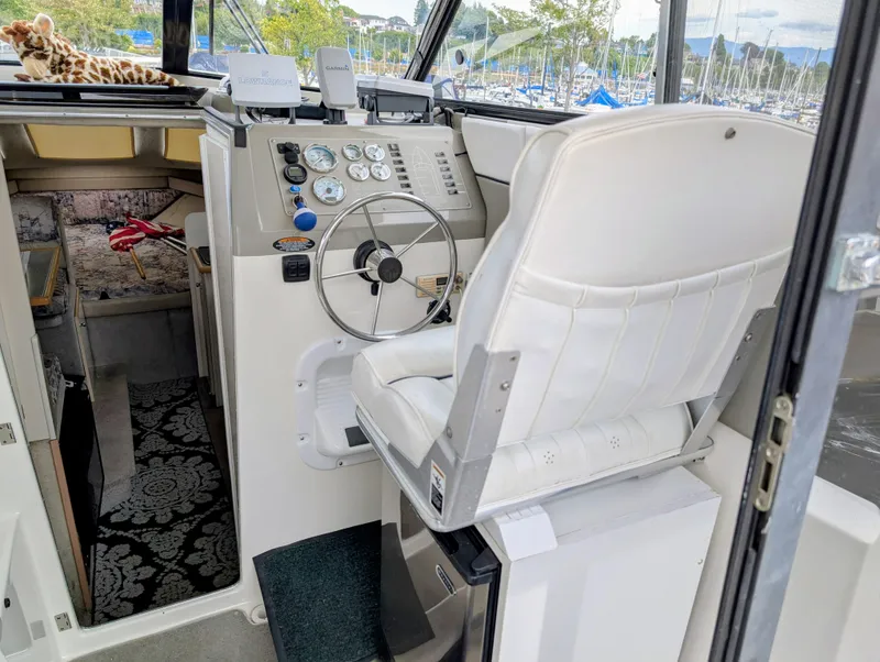 Slide: The Image of Interior of 1997 Bayliner 2859 Ciera Express with steering wheel and white captain's chair. - 19