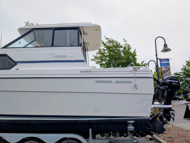 Slide: The Image of 1997 Bayliner 2859 Ciera Express boat with Mercury outboard motor on trailer. - 2