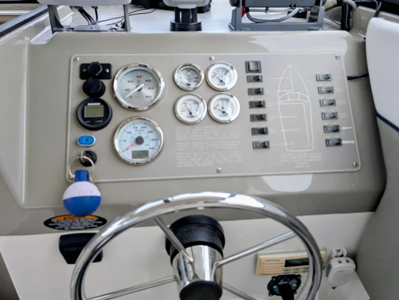 Slide: The Image of Dashboard of a 1997 Bayliner 2859 Ciera Express boat with gauges and controls. - 21