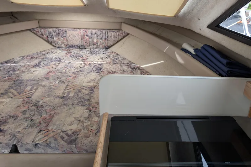 Slide: The Image of 1997 Bayliner 2859 Ciera Express cabin interior with patterned bedding and compact design. - 37