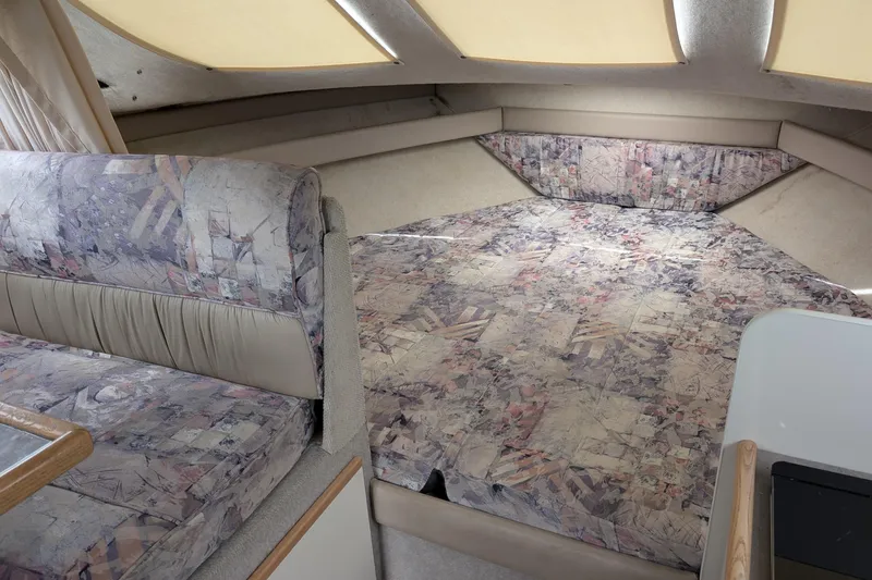 Slide: The Image of 1997 Bayliner 2859 Ciera Express cabin interior with patterned upholstery and cozy sleeping area. - 39