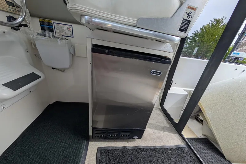 Slide: The Image of 1997 Bayliner 2859 Ciera Express interior with compact Whynter refrigerator. - 48