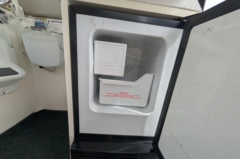 Slide: The Image of Open ice maker inside 1997 Bayliner 2859 Ciera Express boat interior. - 49