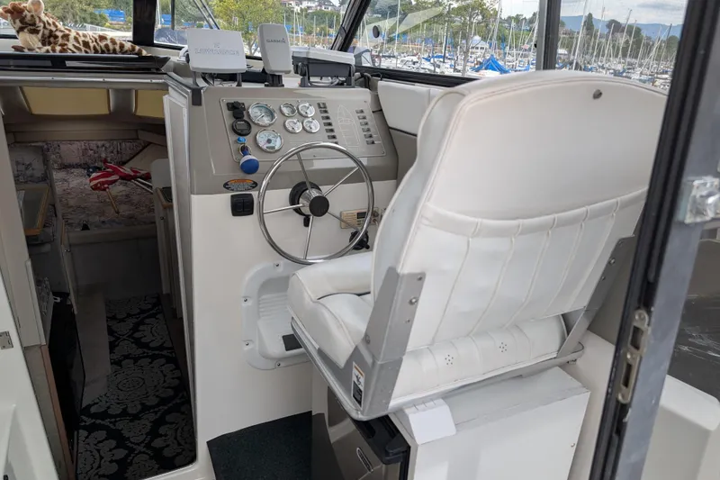 Slide: The Image of Interior of a 1997 Bayliner 2859 Ciera Express boat with steering wheel and controls. - 50