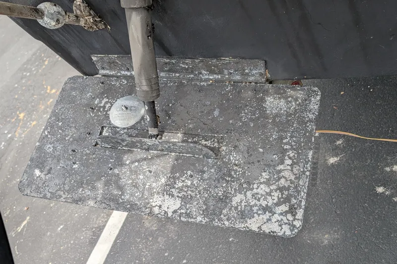 Slide: The Image of 1997 Bayliner 2859 Ciera Express trim tab with corrosion and wear visible. - 7