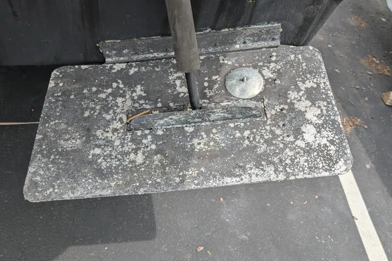 Slide: The Image of 1997 Bayliner 2859 Ciera Express trim tab with corrosion and wear. - 9