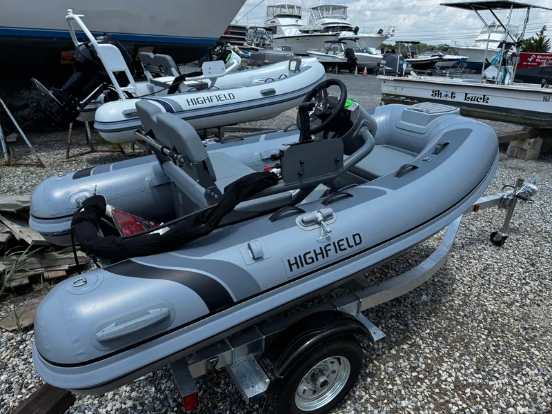 Slide: The Image of 2025 Highfield Classic 290 inflatable boat on trailer, displayed outdoors. - 3