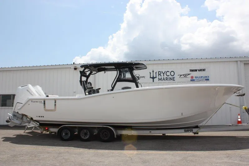 Slide: The Image of 2025 Tidewater 320 CC Adventure boat on trailer, parked outside Ryco Marine building. - 12
