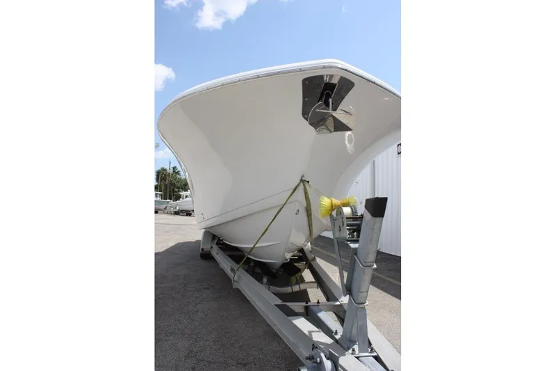 Slide: The Image of 2025 Tidewater 320 CC Adventure boat on trailer, viewed from the front. - 14