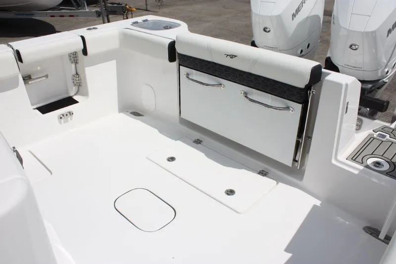Slide: The Image of 2025 Tidewater 320 CC Adventure boat deck with seating and dual Mercury engines. - 17