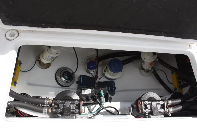 Slide: The Image of 2025 Tidewater 320 CC Adventure boat engine compartment with visible components and wiring. - 18
