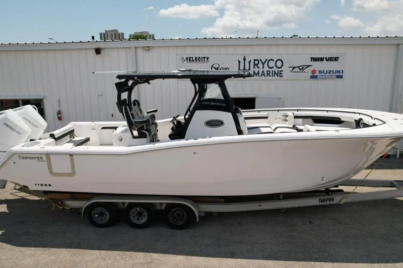 Slide: The Image of 2025 Tidewater 320 CC Adventure boat on trailer at Ryco Marine dealership. - 2