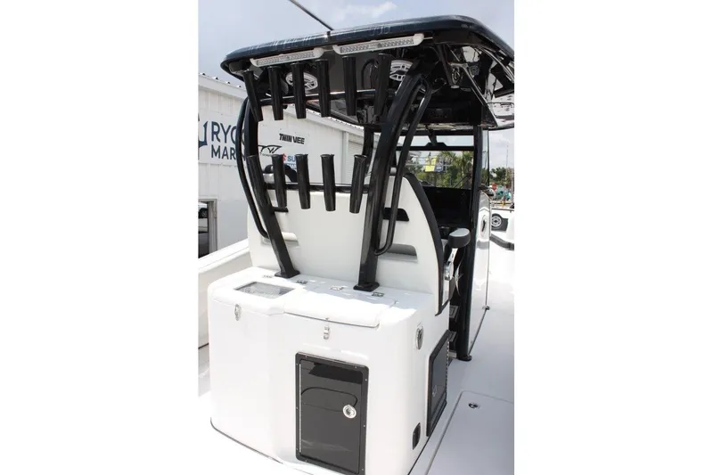 Slide: The Image of 2025 Tidewater 320 CC Adventure boat console with rod holders and storage compartments. - 20
