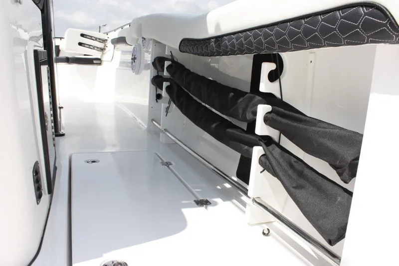 Slide: The Image of 2025 Tidewater 320 CC Adventure boat interior with rod storage and sleek design. - 25