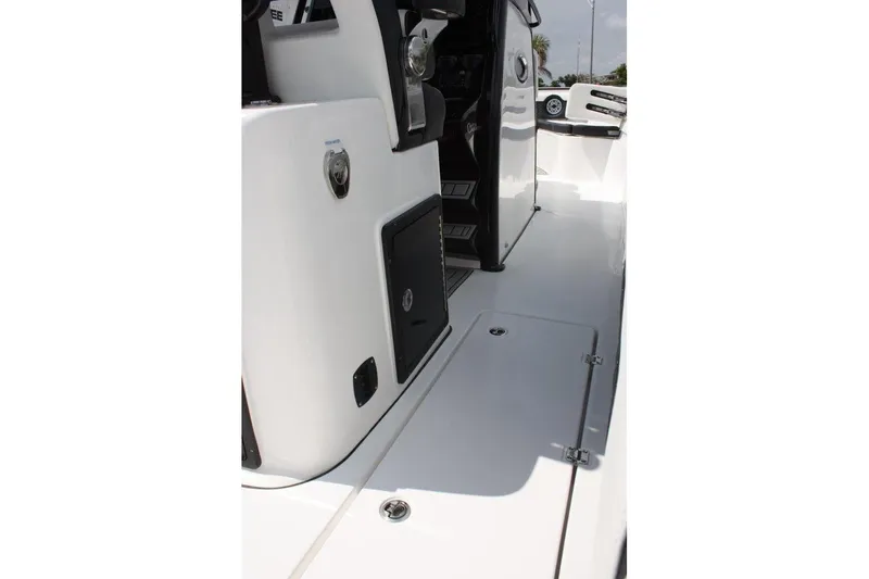 Slide: The Image of 2025 Tidewater 320 CC Adventure boat interior with sleek white deck and storage compartments. - 26