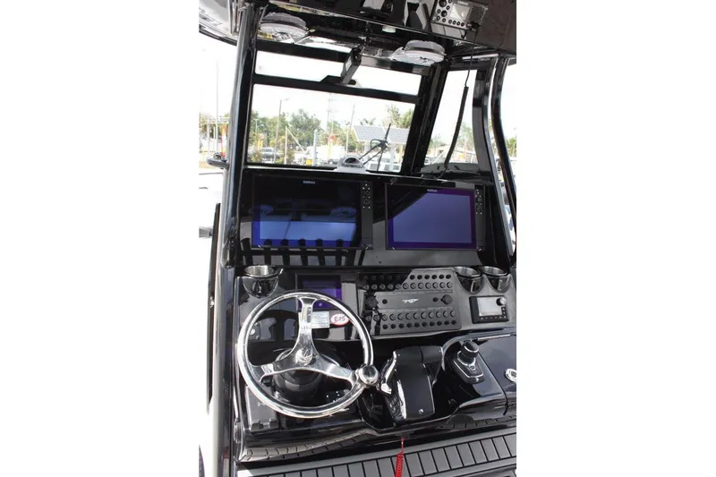 Slide: The Image of 2025 Tidewater 320 CC Adventure boat dashboard with advanced navigation controls. - 27