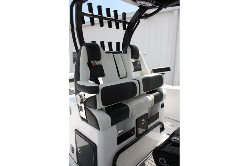 Slide: The Image of 2025 Tidewater 320 CC Adventure boat seating with black and white cushioned design. - 29