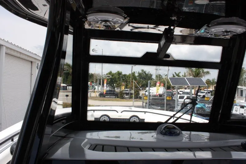Slide: The Image of Interior view of 2025 Tidewater 320 CC Adventure boat, showcasing dashboard and windshield. - 32