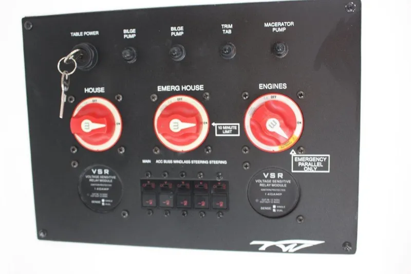 Slide: The Image of Control panel of 2025 Tidewater 320 CC Adventure boat with switches and key. - 33